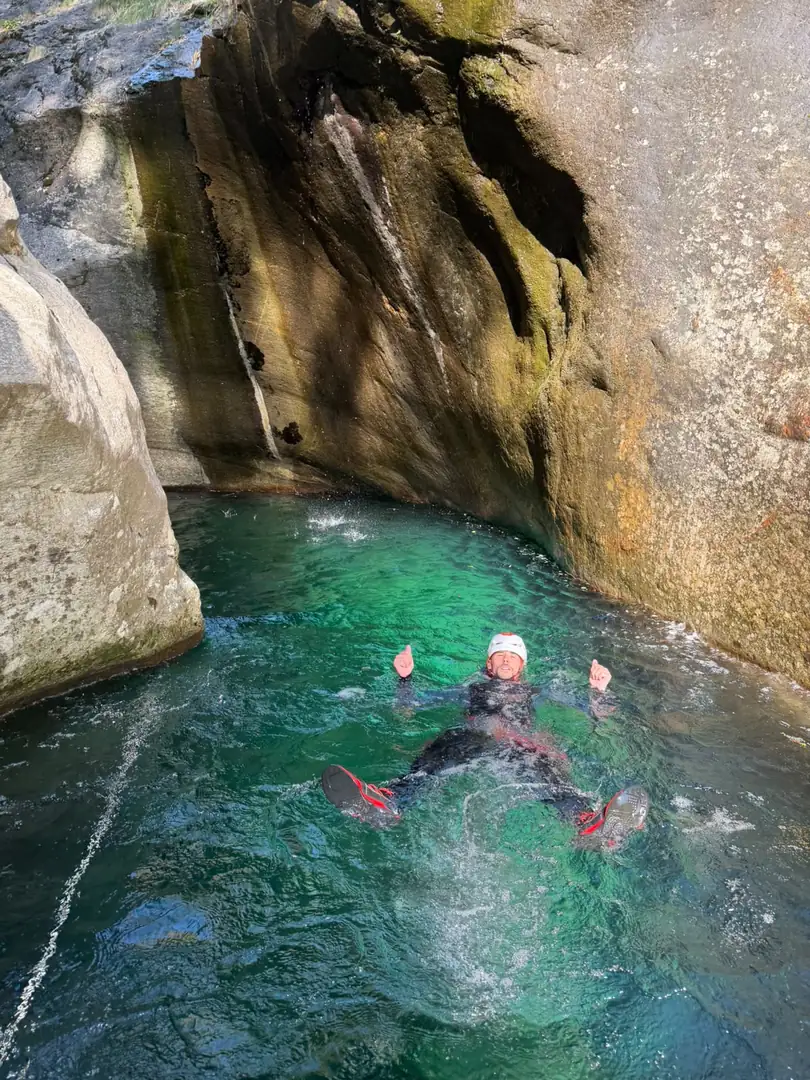 Canyoneur qui flotte dans une vasque vert émeraude du Rio Mondelli, Valle Anzasca